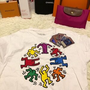 Keith Haring t-shirt featuring a circular graphic of colorful dancing figures